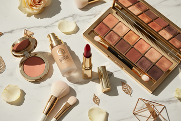 Elegant makeup collection with rose petals and gold accents